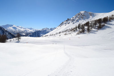 Scenic view of snow covered mountains against sky