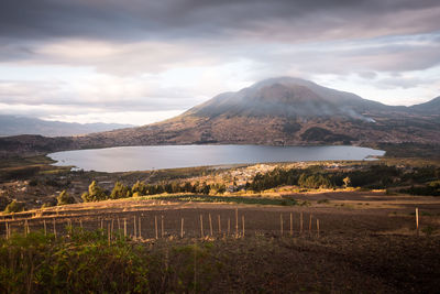 Scenic view of landscape against cloudy sky