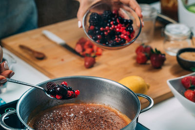 Fruit canning preservation. woman cooking fruits and making homemade jam.