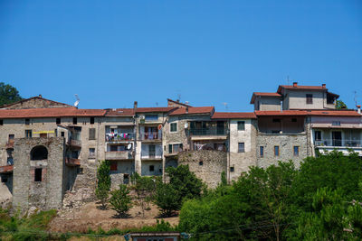 Buildings against clear blue sky