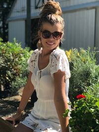 Portrait of smiling young woman wearing sunglasses