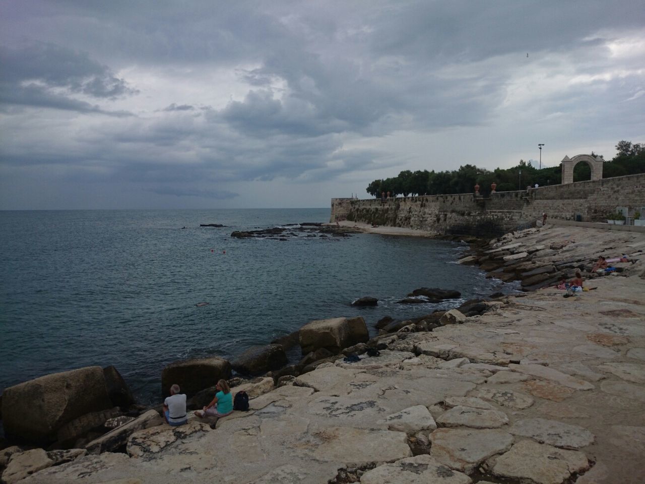 sea, water, sky, beach, horizon over water, shore, cloud - sky, scenics, tranquil scene, tranquility, beauty in nature, rock - object, nature, cloud, cloudy, coastline, sand, idyllic, incidental people