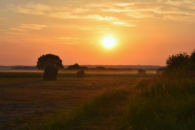 Scenic view of field against sky during sunset