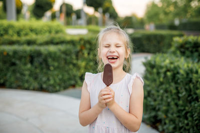 Portrait of smiling girl standing outdoors