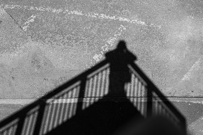 Shadow of man and woman standing on railing