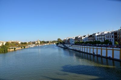 River by town against clear blue sky