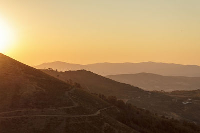 Scenic view of mountains against sky during sunset