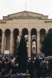 Group of people in front of historical building