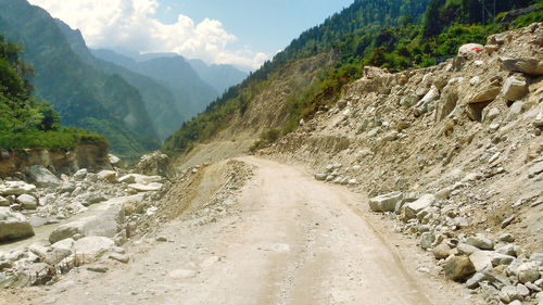 Narrow road along countryside landscape