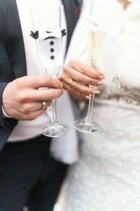 Midsection of man holding wineglass