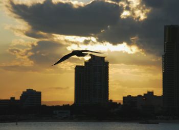 Buildings against sky at sunset