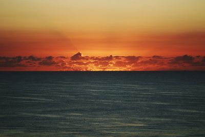 Scenic view of sea against romantic sky at sunset