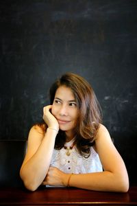 Portrait of smiling young woman sitting