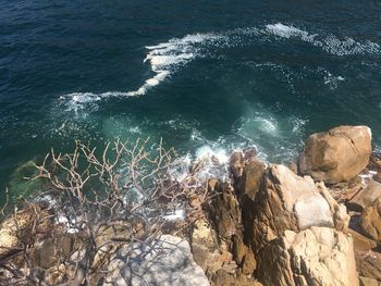 High angle view of rocks in sea