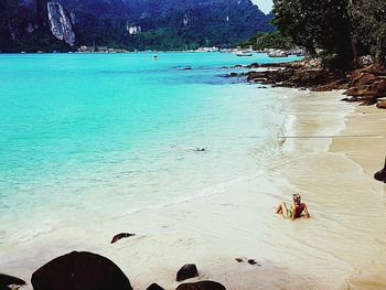 High angle view of people sitting on beach