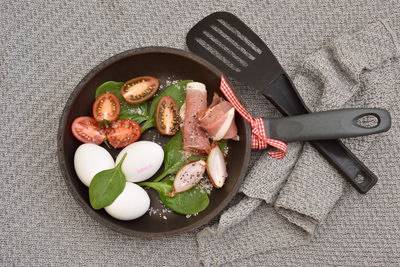 Directly above shot of various eggs on black background