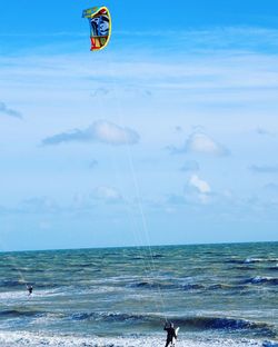 Man surfing in sea against sky