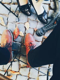 Low section of couple standing on cobblestone