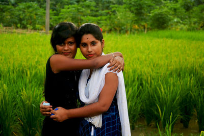 Happy couple standing on field