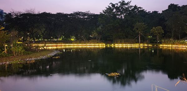 Scenic view of lake against sky at night