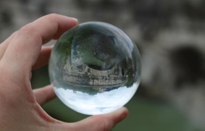 Cropped image of person holding crystal ball