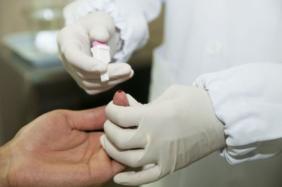 Cropped image of doctor examining patient in hospital