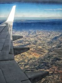 Aerial view of aircraft wing over sea