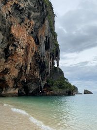 Scenic view of rock formation in sea against sky