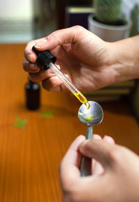 Close-up of woman holding hands on table