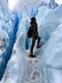 Woman standing on glacier