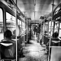 Rear view of people sitting in train