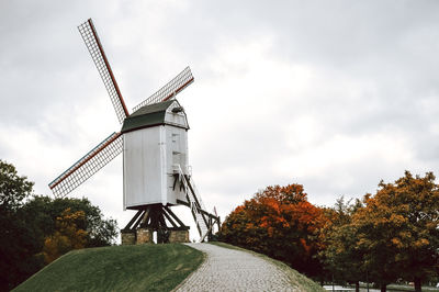 Low angle view of windmill against sky