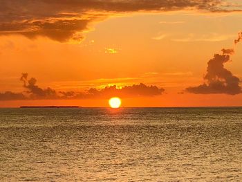 Scenic view of sea against romantic sky at sunset