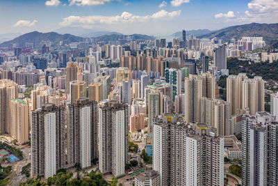 Aerial view of modern buildings in city against sky