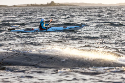 Person kayaking on sea