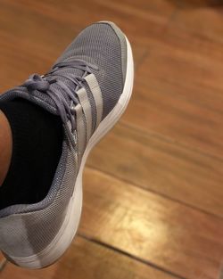 Low section of person wearing canvas shoes