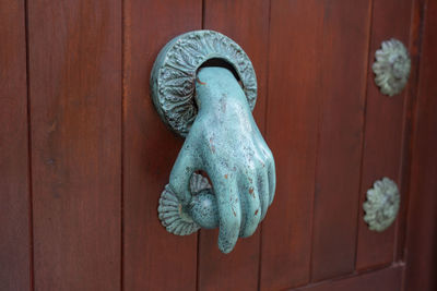 Close-up of knob on wooden door