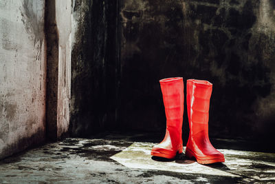 Low section of woman standing in abandoned building