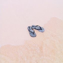 High angle view of slipper on sand