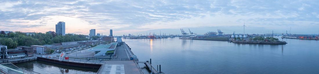 Panoramic view of city by sea against sky