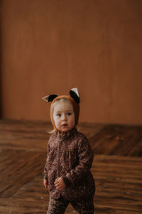 Toddler baby girl in funny hat with ears having fun