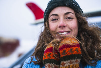 Woman surfer portrait with frozen surfboard