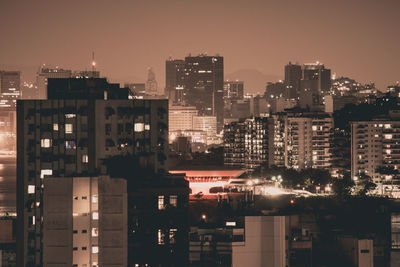 High angle view of illuminated buildings in city at night