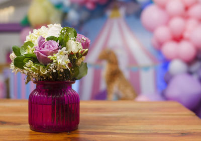 Close-up of pink rose flower vase on table