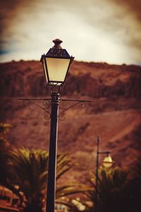 Low angle view of street light against sky at sunset
