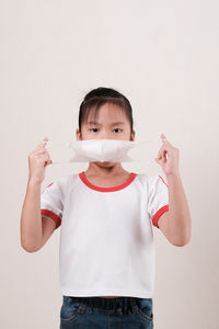 Portrait of cute boy against white background