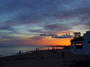 Scenic view of beach against sky during sunset