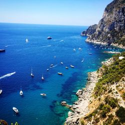 High angle view of boats sailing in sea against clear sky