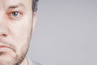 Close-up portrait of man against white background