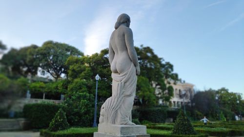 Low angle view of statue against trees